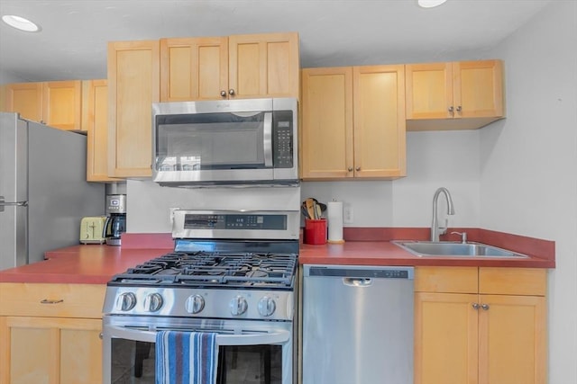 kitchen featuring light brown cabinets, sink, and stainless steel appliances