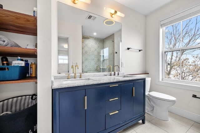 bathroom with a shower stall, a wealth of natural light, and a sink