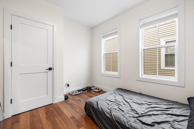 bedroom featuring baseboards and wood finished floors