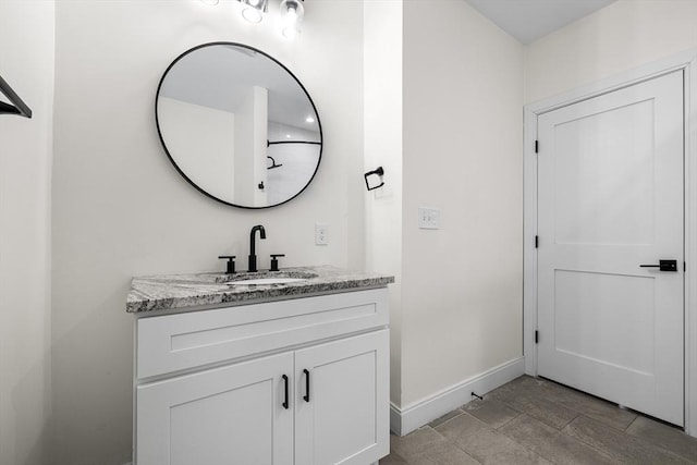 bathroom with vanity and baseboards