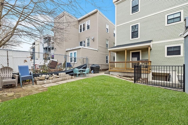 rear view of house featuring a yard, a patio, and fence