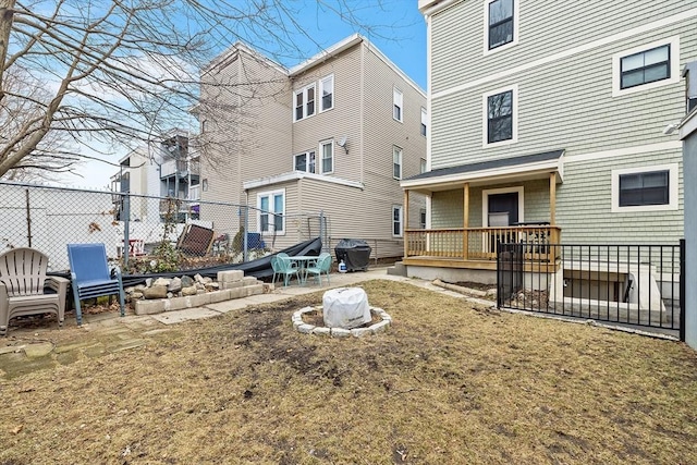 rear view of house featuring a patio, an outdoor fire pit, and fence