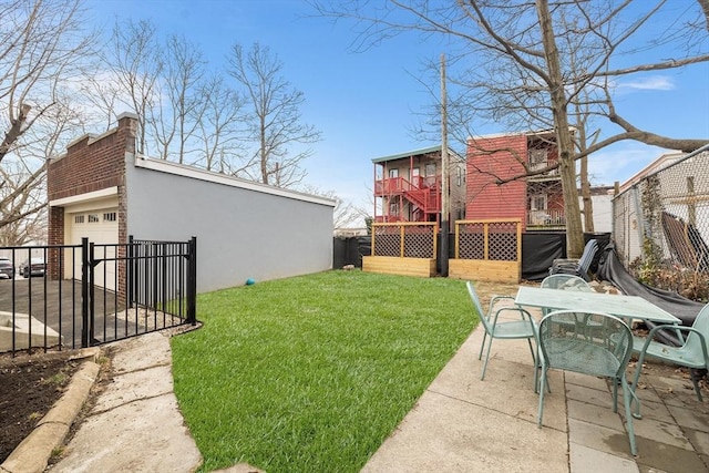 view of yard with outdoor dining space, an outdoor structure, and fence