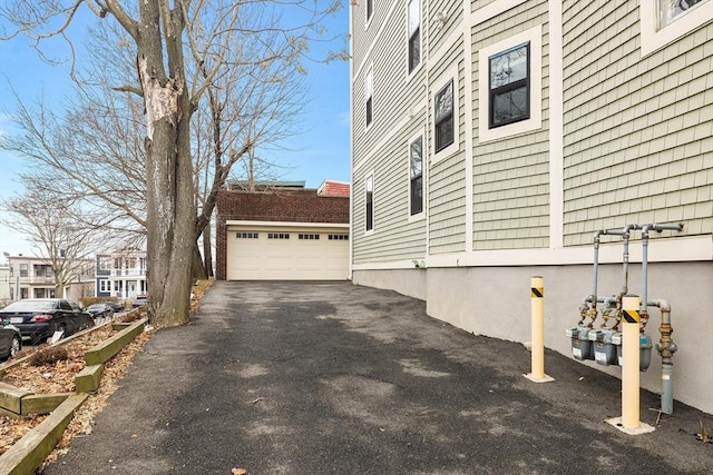 view of side of property with an outdoor structure and a garage