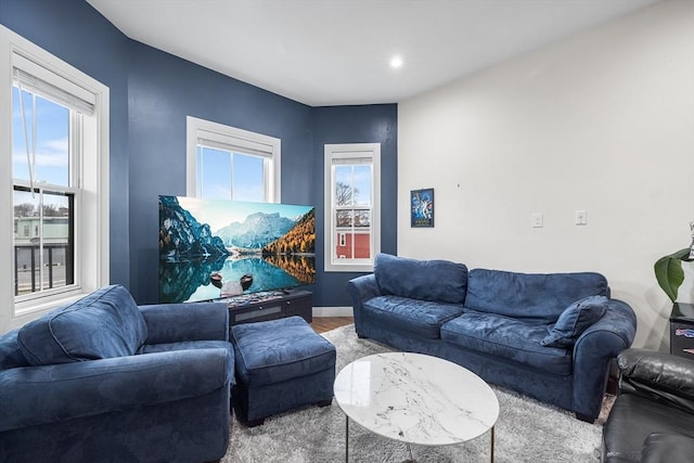 living area with baseboards and a wealth of natural light