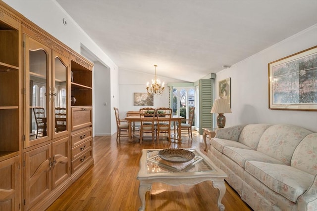 living room with wood finished floors, lofted ceiling, and a chandelier