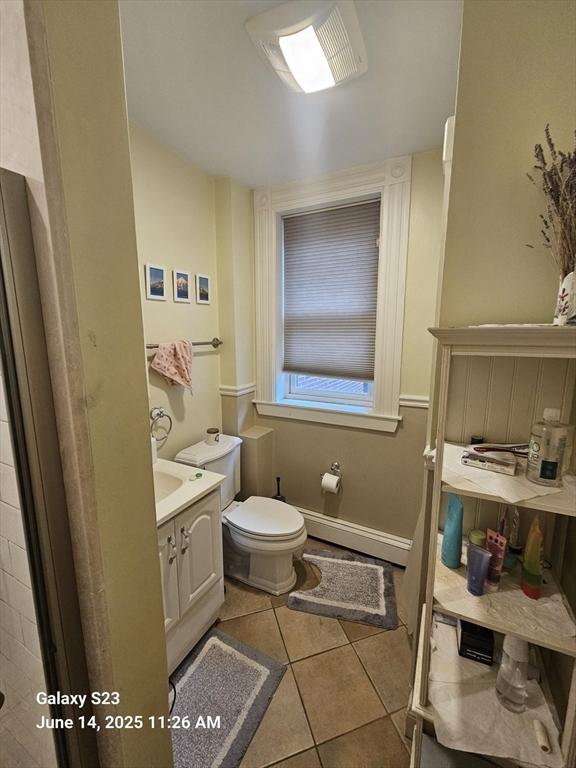 6 Stillman Pl, Boston, MA 02113 - bathroom with vanity, a baseboard heating unit, and tile patterned floors