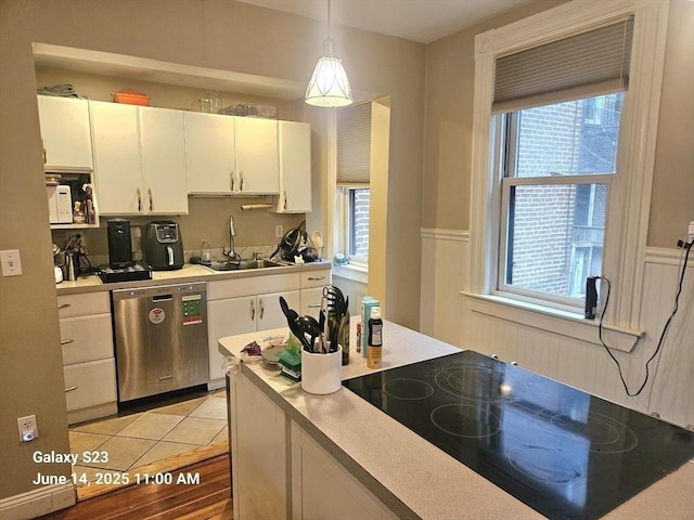 6 Stillman Pl, Boston, MA 02113 - kitchen featuring dishwasher, black electric stovetop, white cabinetry, light countertops, and pendant lighting