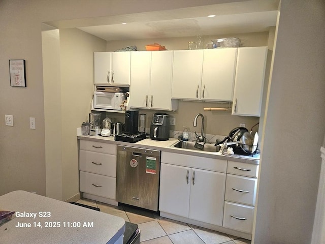 6 Stillman Pl, Boston, MA 02113 - kitchen with dishwasher, white microwave, light tile patterned floors, light countertops, and white cabinets
