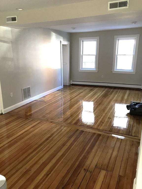 6 Stillman Pl, Boston, MA 02113 - empty room with wood-type flooring and a baseboard radiator