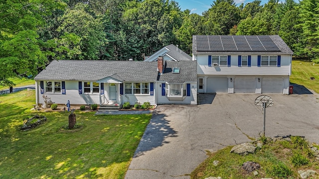 view of front of property featuring a garage and a front lawn