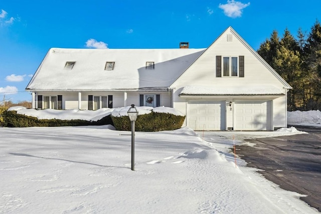 view of front facade featuring a chimney and an attached garage