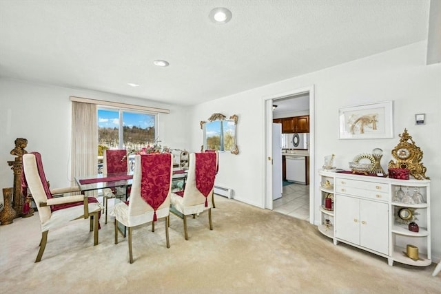 dining area featuring a baseboard radiator, light colored carpet, and recessed lighting