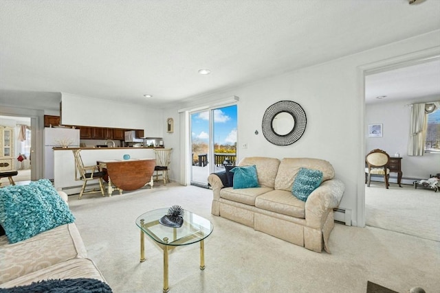 living area featuring baseboard heating and light colored carpet