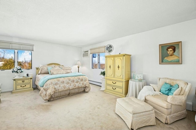 bedroom with a wall unit AC, a baseboard heating unit, and light colored carpet