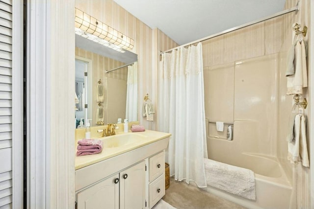 bathroom with shower / tub combo, vanity, and wallpapered walls