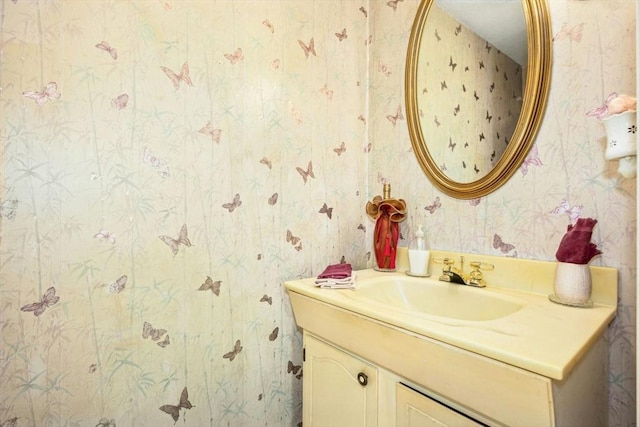 bathroom with vanity and wallpapered walls