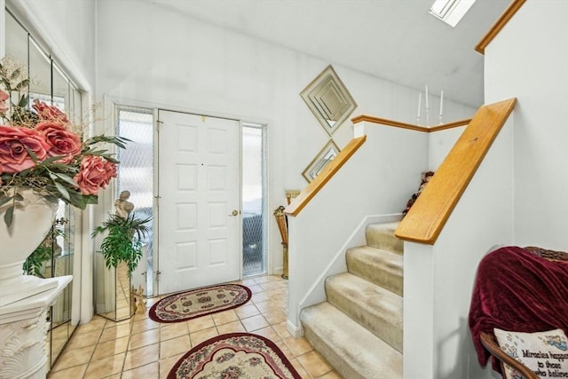 entryway with stairway and light tile patterned floors