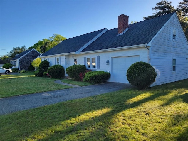 115 Captain Chase Rd, Yarmouth, MA 02664 - view of front of property featuring a garage, a chimney, a front lawn, driveway, and a shingled roof