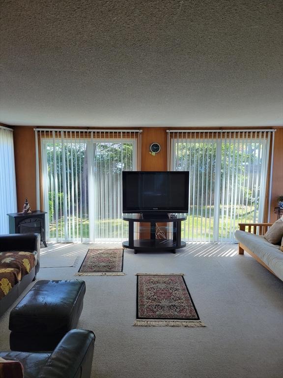 115 Captain Chase Rd, Yarmouth, MA 02664 - living area featuring carpet and a textured ceiling