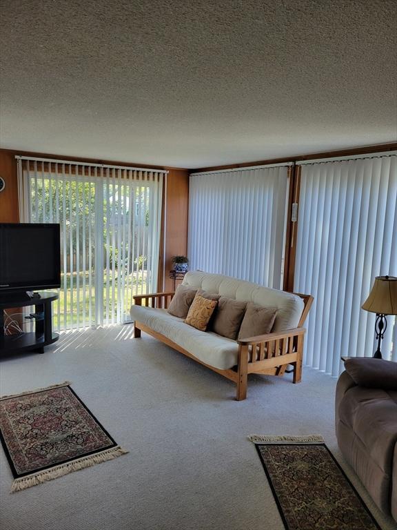 115 Captain Chase Rd, Yarmouth, MA 02664 - living room with carpet flooring and a textured ceiling