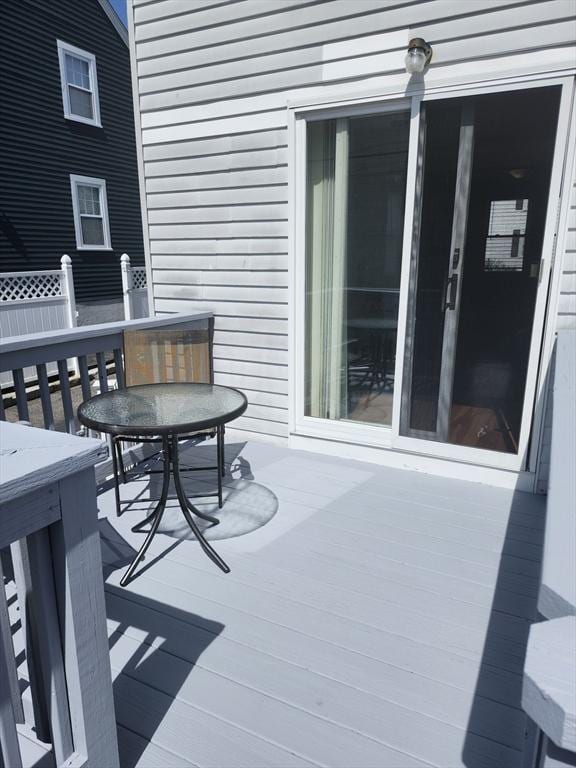 wooden terrace featuring outdoor dining area
