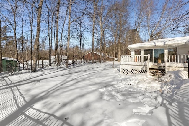 snow covered deck with fence