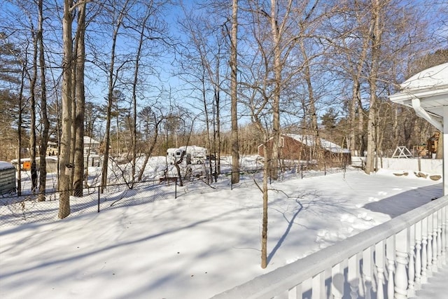 yard covered in snow with fence