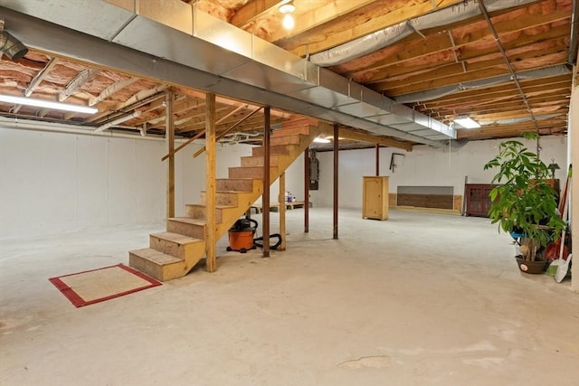 unfinished basement featuring stairs