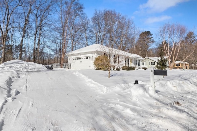 view of snow covered exterior featuring an attached garage