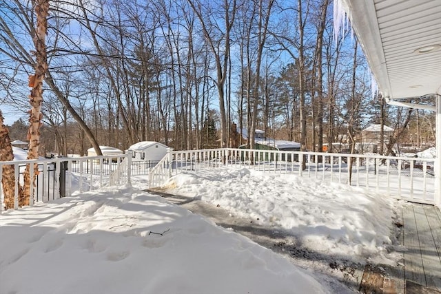 snowy yard featuring a deck