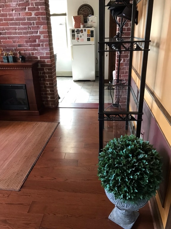 corridor with hardwood / wood-style flooring