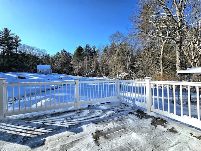 snow covered pool with a deck