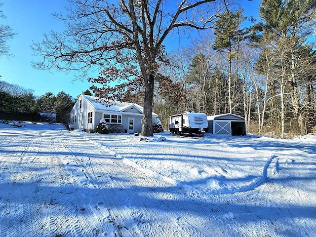 snowy yard featuring an outbuilding