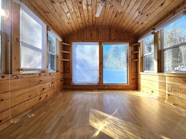 interior space featuring hardwood / wood-style floors, wooden walls, a wealth of natural light, vaulted ceiling, and wooden ceiling