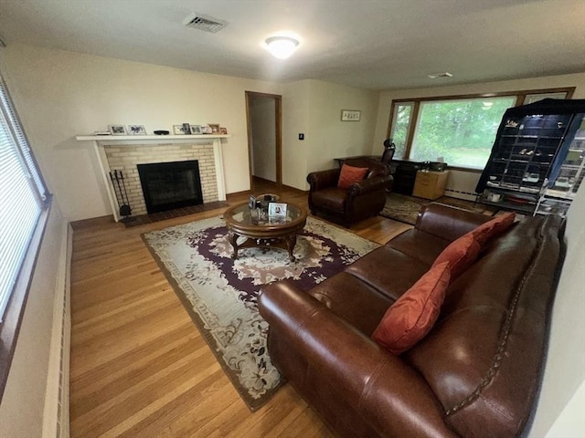 330 Chapin St, Ludlow, MA 01056 - living room with wood finished floors, a fireplace, and a baseboard radiator