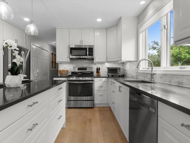 29 Shermans Way, Westwood, MA 02090 - kitchen with stainless steel appliances, recessed lighting, decorative backsplash, and white cabinetry