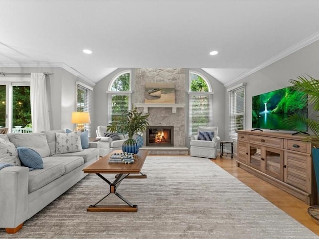 29 Shermans Way, Westwood, MA 02090 - living room featuring vaulted ceiling, wood finished floors, a stone fireplace, ornamental molding, and recessed lighting