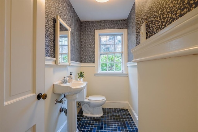 bathroom with sink, lofted ceiling, toilet, and tile patterned flooring