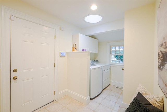 washroom featuring washing machine and dryer and cabinets