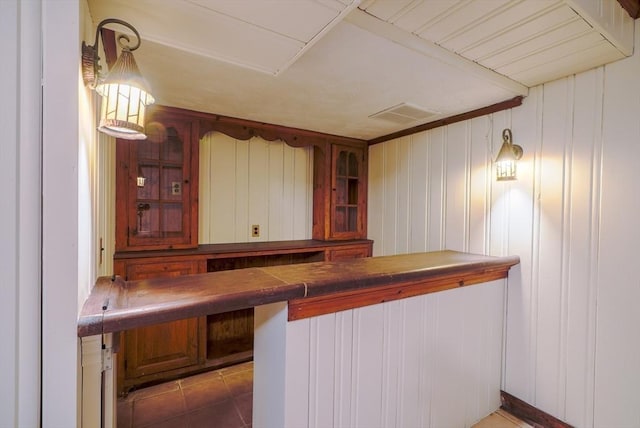 bar featuring hanging light fixtures and dark tile patterned flooring