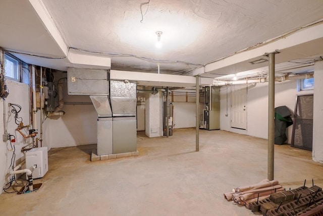 basement with water heater and heating unit