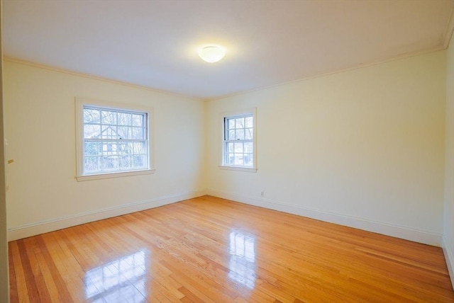 unfurnished room with ornamental molding and light hardwood / wood-style floors