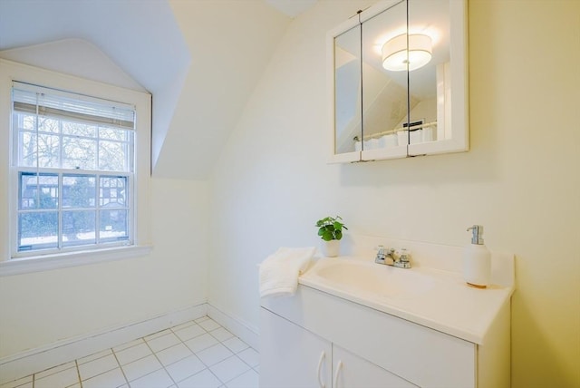 bathroom with vanity, lofted ceiling, and tile patterned floors