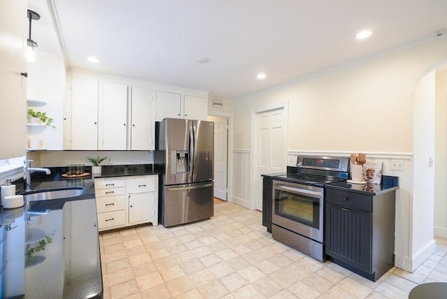 kitchen with ornamental molding, appliances with stainless steel finishes, sink, and white cabinets