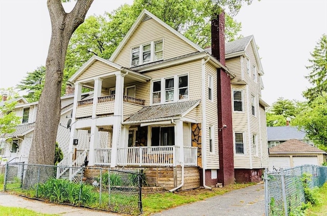 58-60 Virginia St, Springfield, MA 01108 - view of front of property featuring a balcony, covered porch, a fenced front yard, a chimney, and an outbuilding