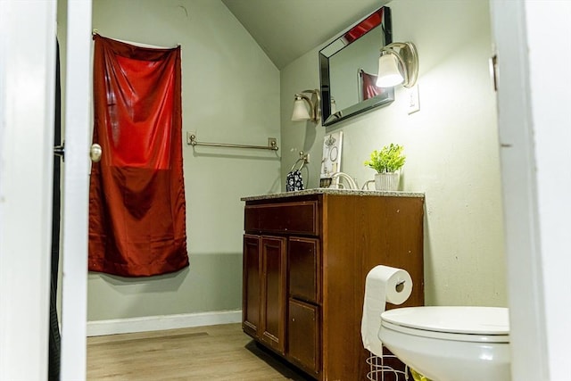 58-60 Virginia St, Springfield, MA 01108 - bathroom featuring vaulted ceiling, wood finished floors, toilet, baseboards, and vanity