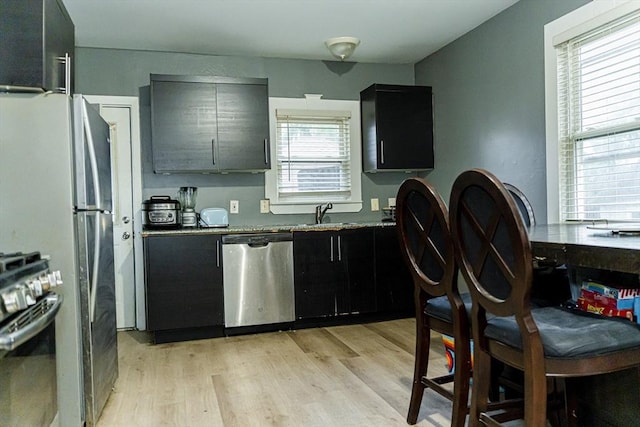 58-60 Virginia St, Springfield, MA 01108 - kitchen with stainless steel appliances, light wood-type flooring, dark cabinets, and a sink