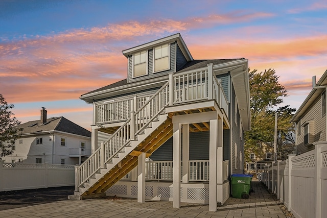 back house at dusk with a patio