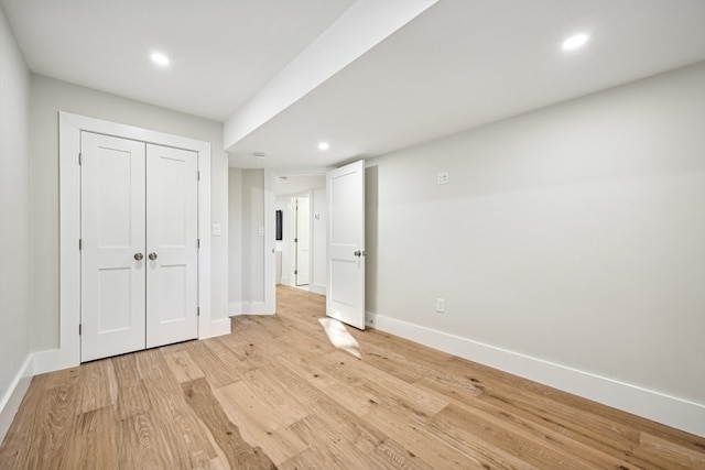 unfurnished bedroom with a closet and light hardwood / wood-style flooring